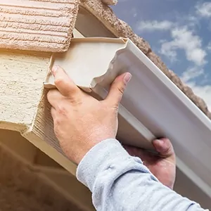 Closeup of hands installing a K-style gutter.