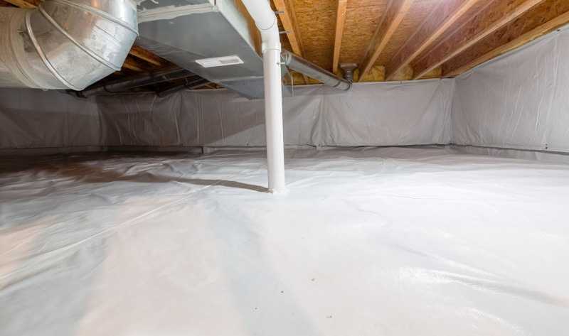 An encapsulated crawl space featuring a clean white vapor barrier.