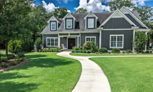 Grey House with green grass in the front yard