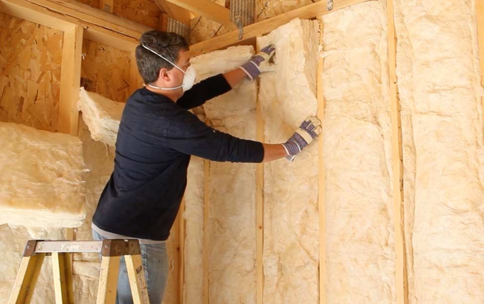 Fiberglass Batts insulation installer