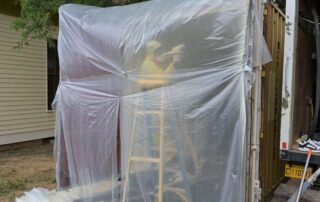 container-exterior-prep-little-rock.jpgG&S Insulating technician on ladder spraying closed cell spray foam on exterior of plastic-wrapped storage container in Little Rock, AR.