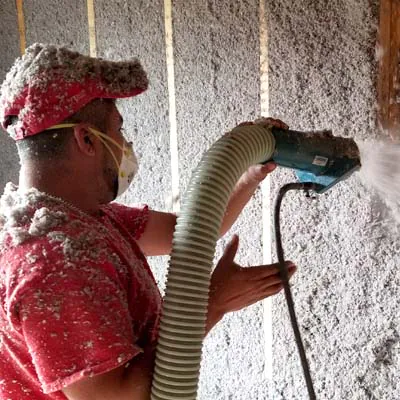G&S Insulating installer blowing cellulose insulation into an open wall cavity in Little Rock, AR.