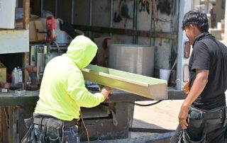 G&S Insulating crew guiding a freshly formed seamless gutter. G&S Insulating crew guiding a freshly formed seamless gutter off the roll-forming machine in Little Rock, AR.