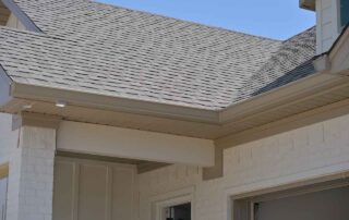 G&S Insulating seamless gutter along a gable roof. G&S Insulating seamless gutter along a gable roof above a home entryway in Little Rock, AR.