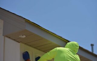 G&S Insulating technician measuring roof eave for gutter installation. G&S Insulating technician measuring roof eave for gutter installation on a home in Little Rock, AR.