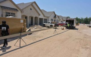 G&S Insulating crew carrying a freshly formed gutter. G&S Insulating crew carrying a freshly formed gutter length across a new construction site in Little Rock, AR.