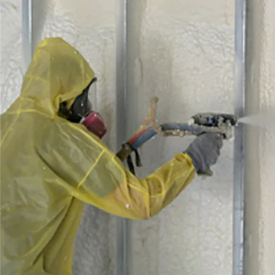 G&S Insulating technician close-up applying open-cell spray foam in Little Rock, AR.