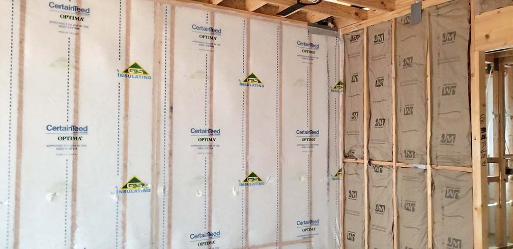G&S Insulating CertainTeed OPTIMA blown-in fiberglass wall system with Johns Manville faced batt insulation on adjacent wall, Little Rock, AR.