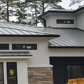 G&S Insulating gutter and downspout installation on home exterior in Little Rock, AR.